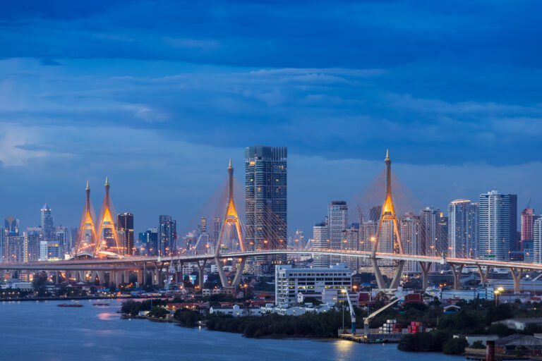 Large suspension bridge over Chao Phraya river at twilight, with