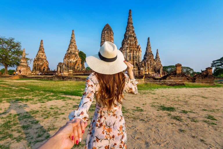 Woman holding man's hand and leading him to Ayutthaya Historical